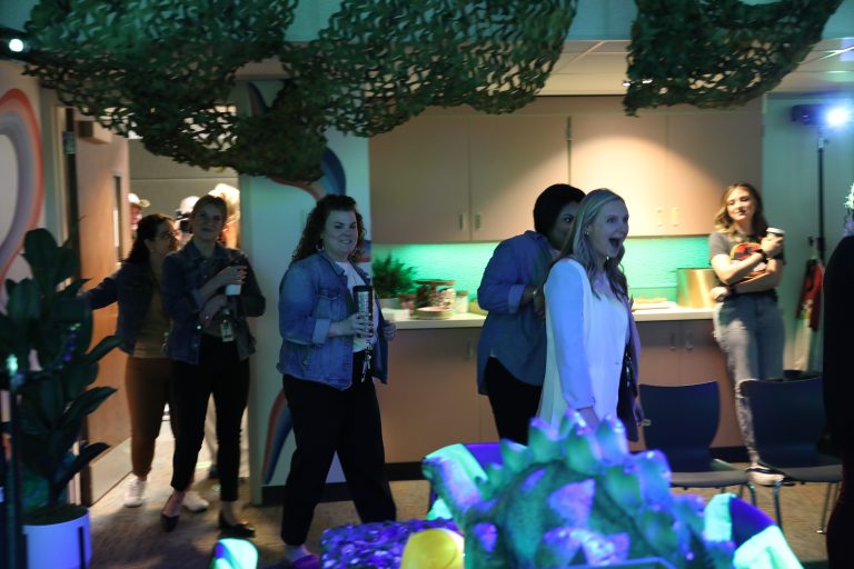 Party in a room decorated with jungle theme elements.