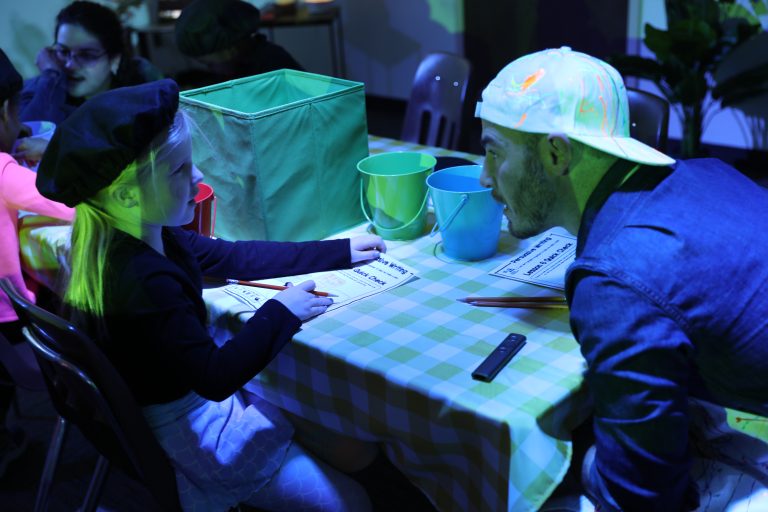 Two people sitting at a table in a room.