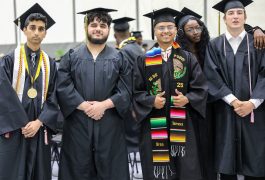 Students dressed in caps & gowns for graduation