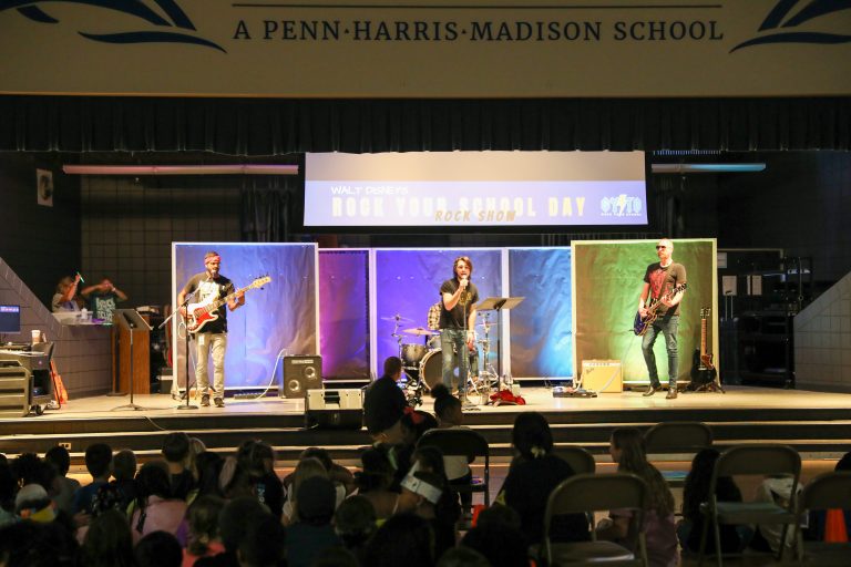 A band performing on a stage in front of an audience.