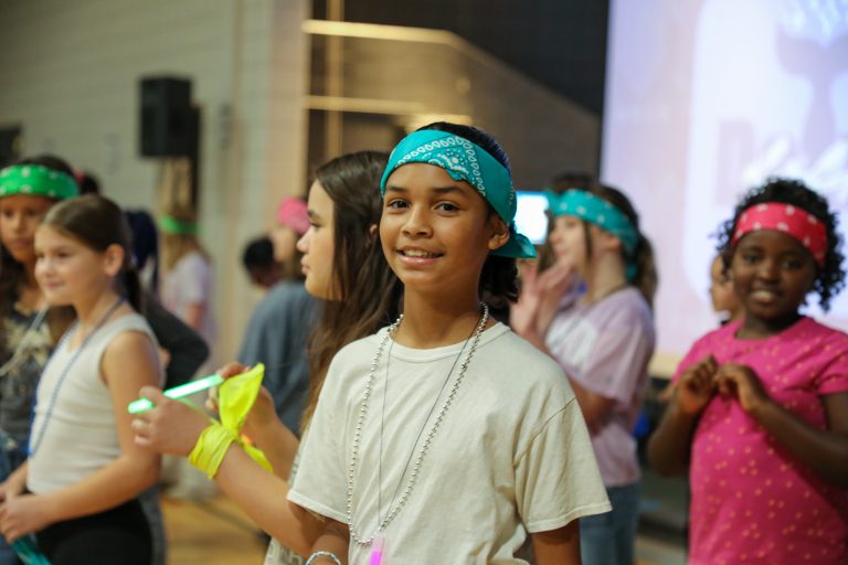 Children in colorful bandanas posing for a group photo.