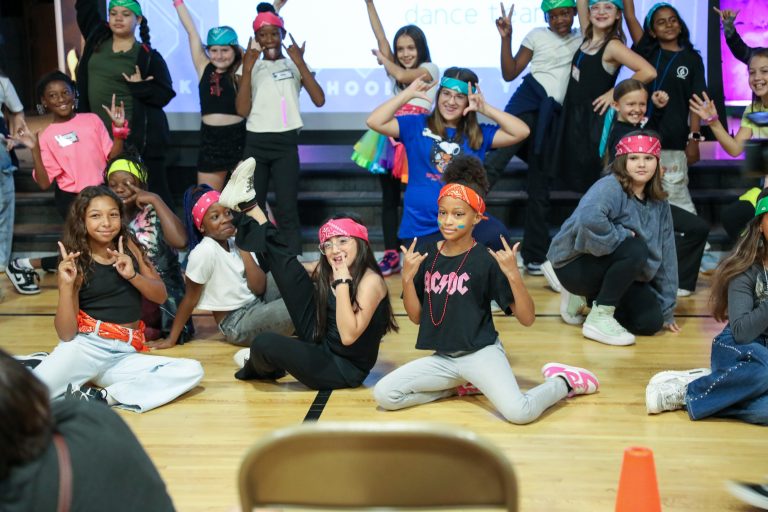 Group of people posing on stage for a picture.