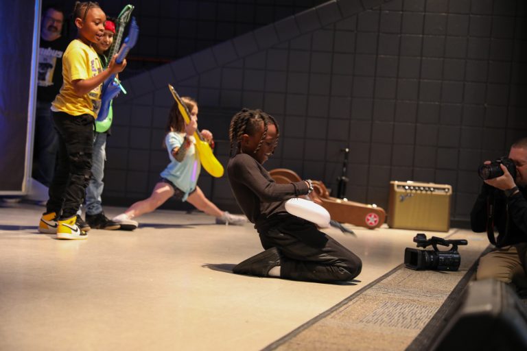 People playing musical instruments on stage.