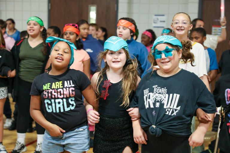 Children in costumes posing for a picture.