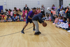 Two men playing basketball on a court.